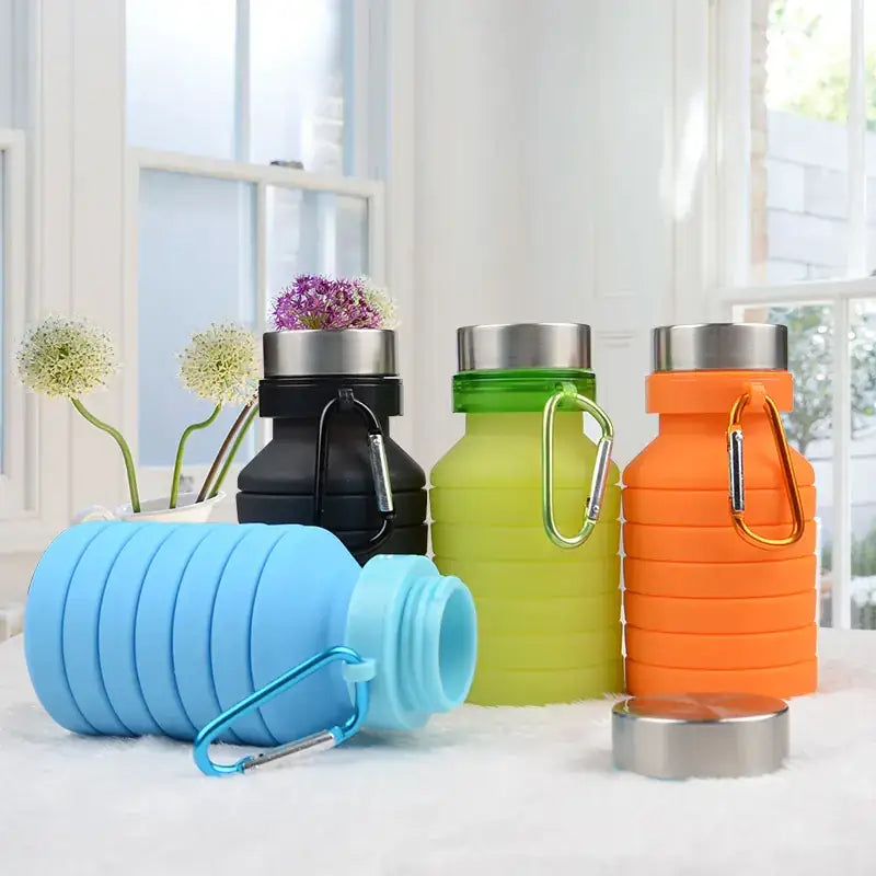 Blue collapsible silicone water bottle with a silver carabiner clip and screw-on lid