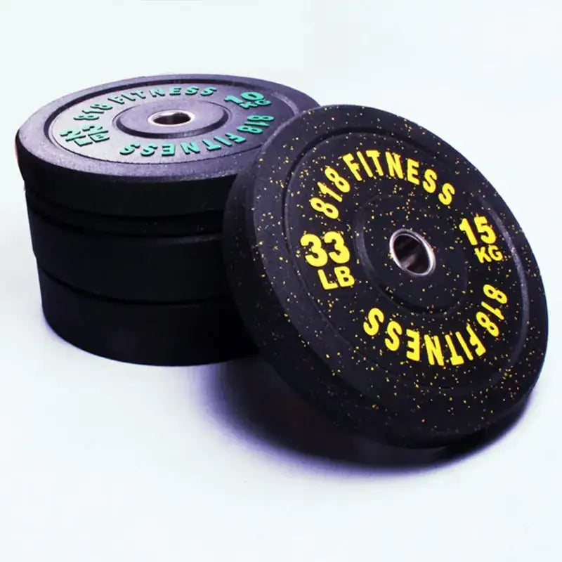 Black rubber weight plates with yellow and green text, featuring ’818 fitness’ branding.