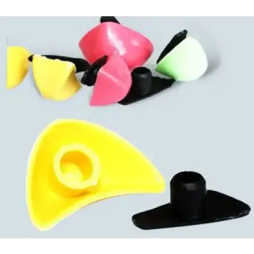Brightly colored plastic guitar capo clips in pink, yellow, and green with black bases.