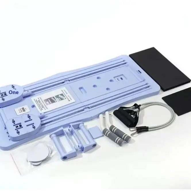Light blue plastic fitness trainer with black foam pads and resistance bands.