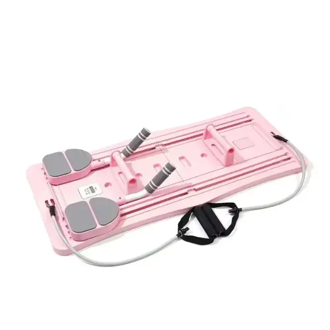 Pink plastic exercise board with gray foot pads and black resistance bands.