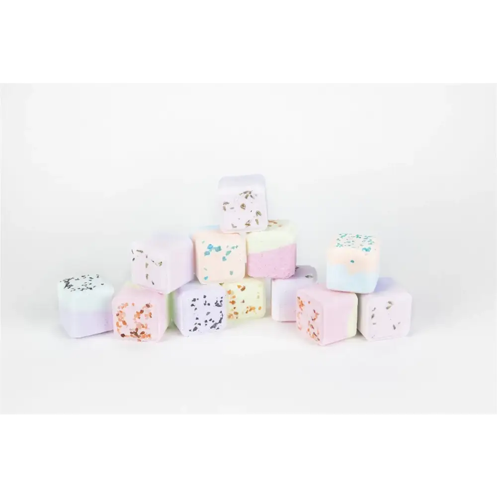 Pastel-colored bath bombs with speckled and layered designs.