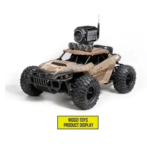 Tan and black remote-controlled off-road vehicle with rugged tires, a mounted camera on the roof, and tactical detailing.
