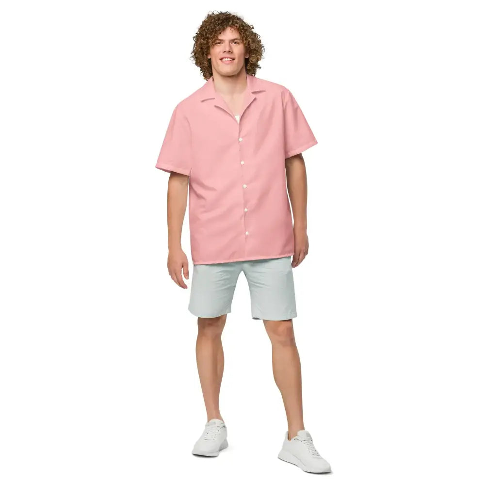 A soft pink, short-sleeved button-up shirt with a classic collar and neatly stitched seams.