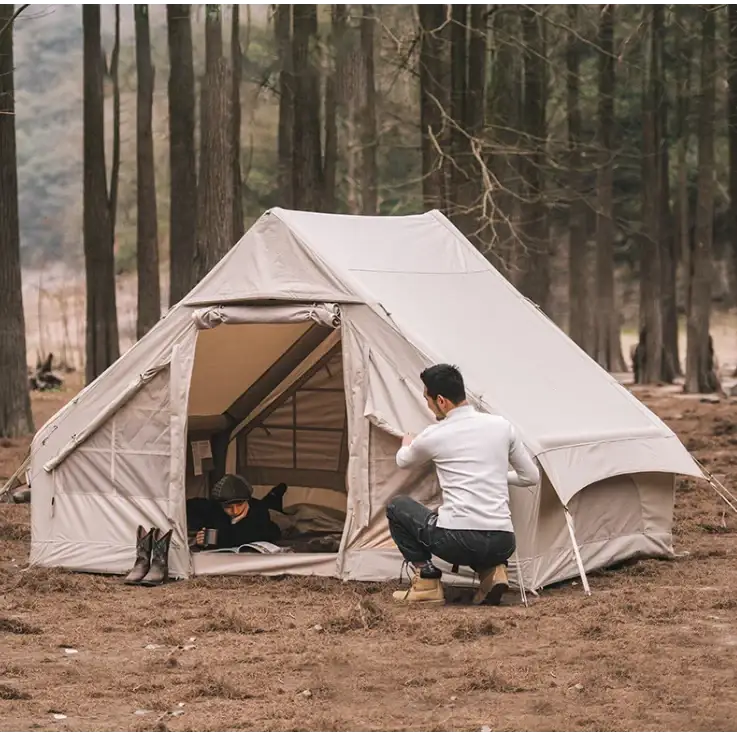 Beige canvas bell tent with a spacious interior and sturdy poles.