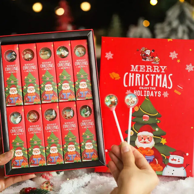 Red christmas-themed candy box with festive illustrations of santa claus and a tree, containing twelve individually wrapped lollipops.