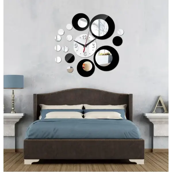Black and silver circular mirror clock with a central white face.