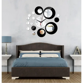 Black and silver circular mirror clock with a central white face.