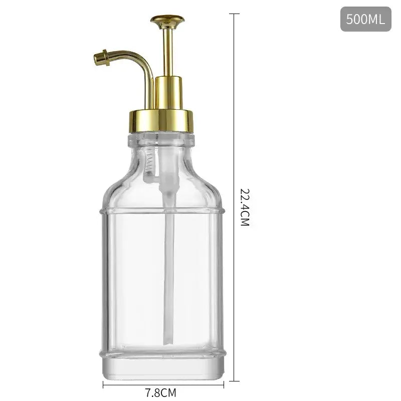 Clear glass soap dispenser with a gold-tone pump and spout, 500ml capacity.