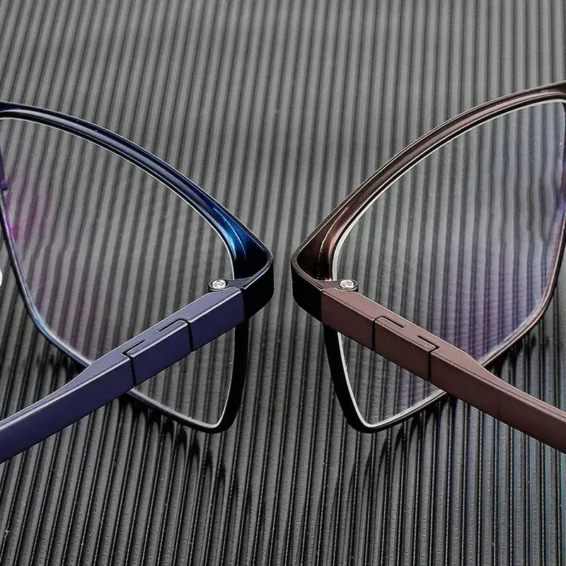 A pair of sleek, modern reading glasses with gradient blue and brown metallic frames.