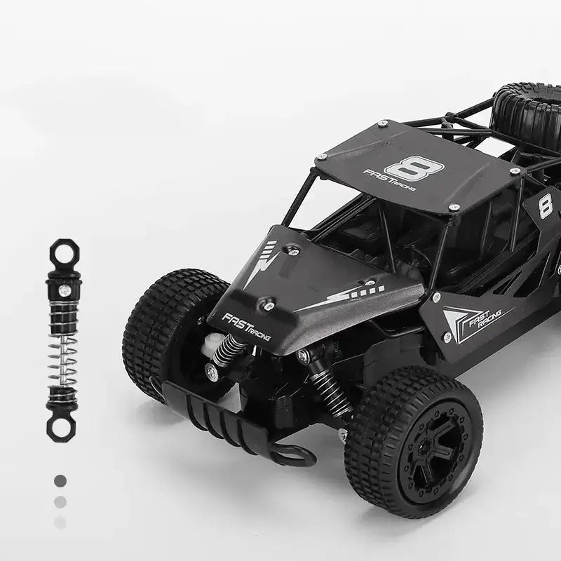 Black plastic remote-controlled off-road racing truck with ’fast racing’ branding and number 8 decals.