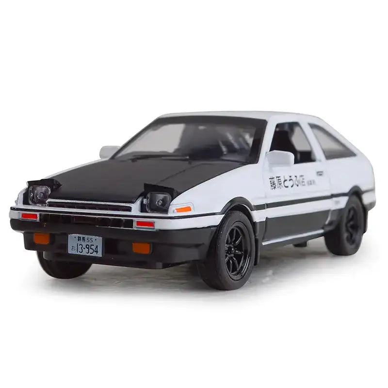 White and black diecast model of a toyota ae86 with ’藤原とうふ店’ lettering on the side.