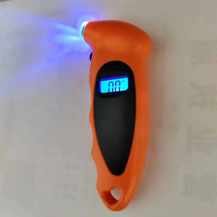 Orange handheld tire pressure gauge with a blue led display and glowing blue light at the tip.