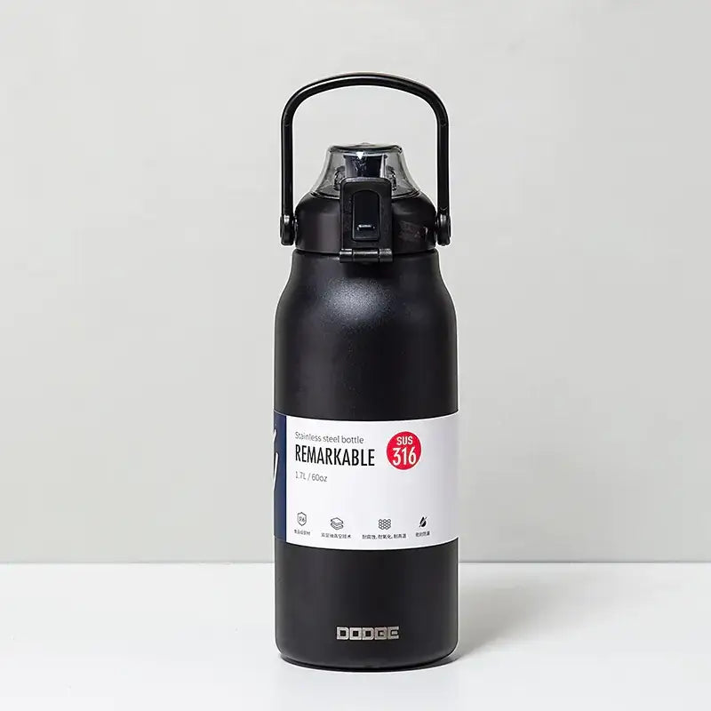 Black stainless steel water bottle with a handle and screw-on lid, featuring a white label that reads ’remarkable’ and the brand name ’dodge’.