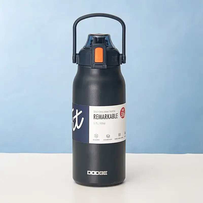 Black stainless steel water bottle with a handle and orange accent on the lid, featuring a white label that reads ’remarkable’ by dodge.