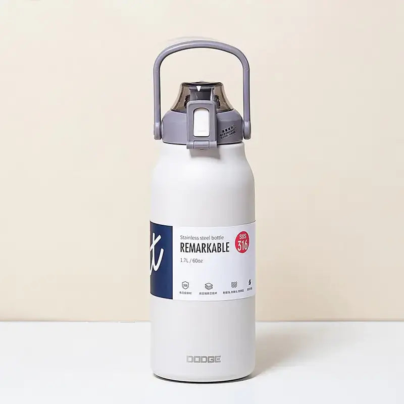 White stainless steel water bottle with a gray handle and lid, featuring the ’remarkable’ label and ’dodge’ branding.