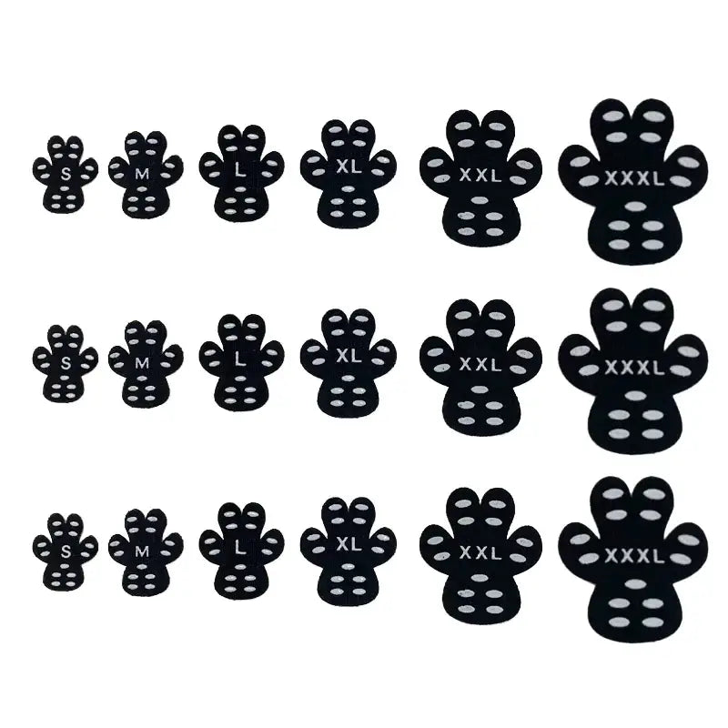 Black paw-shaped adhesive foot grips with white circular dots and size labels.