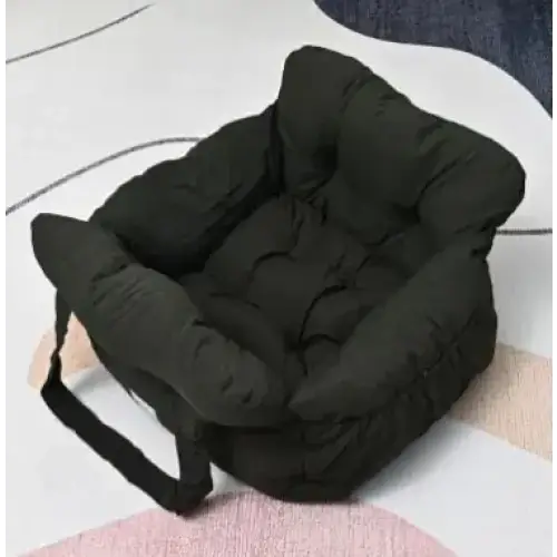 Black padded car seat cushion with a soft, quilted design and an attached handle.