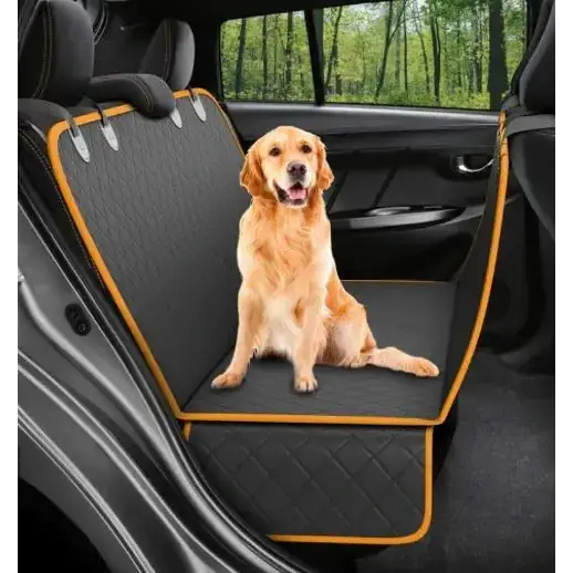 Black quilted car seat cover with orange trim, featuring a golden retriever sitting comfortably on it.