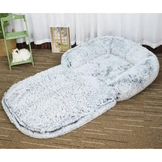Fluffy gray and white faux fur pet bed with a cozy, cushioned design.