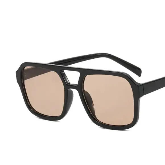 Black aviator-style sunglasses with tan-tinted lenses and a sleek, modern frame design.