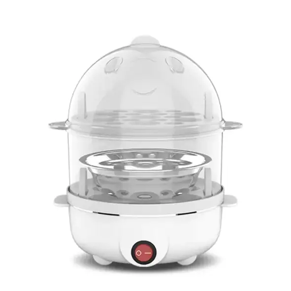 White electric egg cooker with transparent dome lid featuring a cute smiling face design and stainless steel steaming tray.