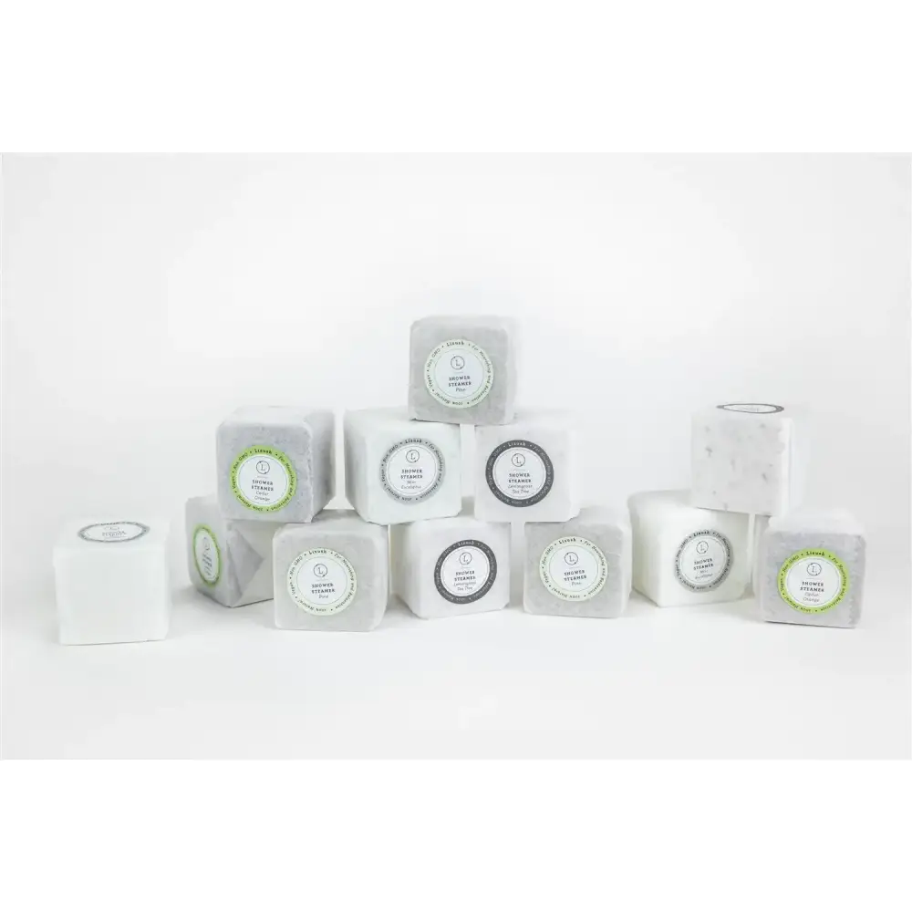 White and gray marble-effect cubes with circular labels featuring the ’scented stones’ brand name.