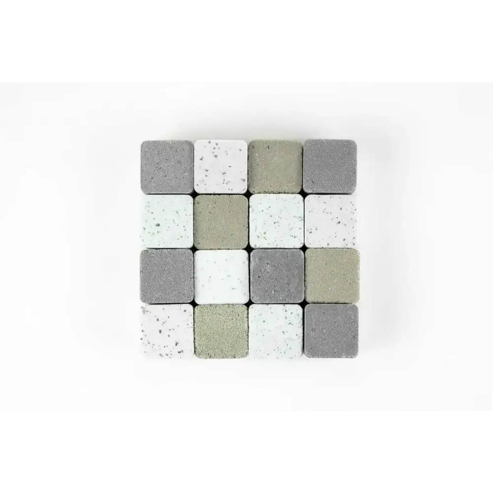 A collection of square concrete pavers in varying shades of gray, white, and beige with speckled textures.