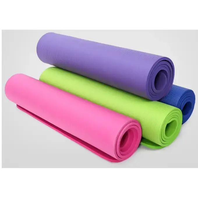 A stack of colorful, rolled yoga mats in vibrant pink, lime green, purple, and blue.