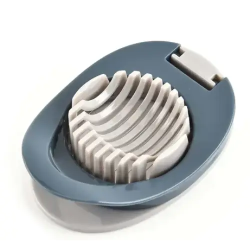 Gray plastic egg slicer with a curved, ridged cutting surface and a hinged lid.