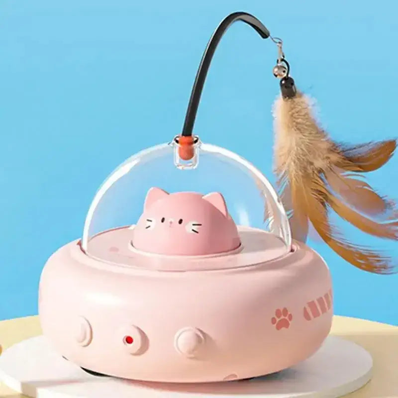 Pink cat-shaped electric pet toy with clear dome and feather wand attachment.