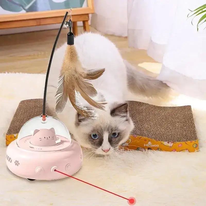 Pink ufo-shaped cat toy with a clear dome, feather wand, and red laser pointer.