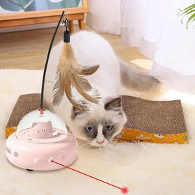 Pink ufo-shaped cat toy with a clear dome, feather wand, and red laser pointer.
