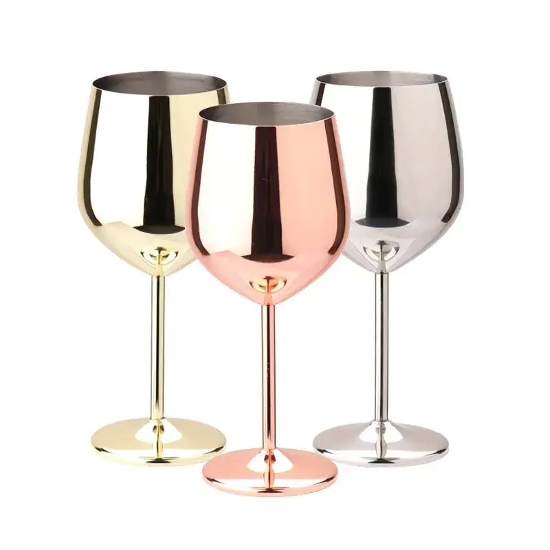 Three sleek, metallic wine glasses in gold, rose gold, and silver finishes with a modern, reflective design.