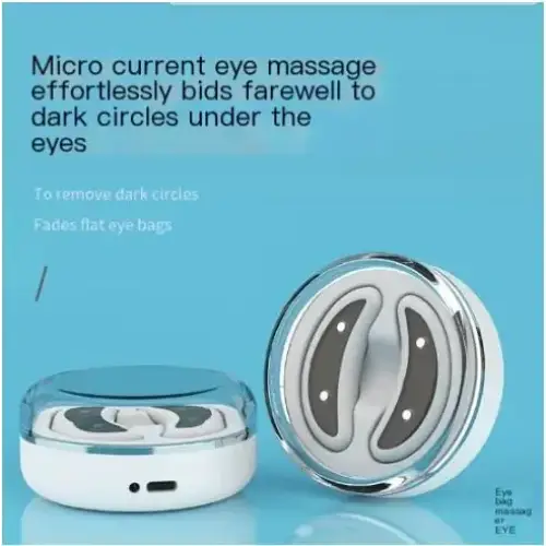 White and silver micro current eye massage device with a sleek, circular design featuring two curved electrode pads.