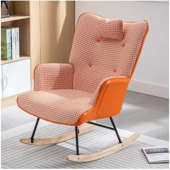 Orange and beige houndstooth patterned rocking chair with orange fabric accents and black metal legs