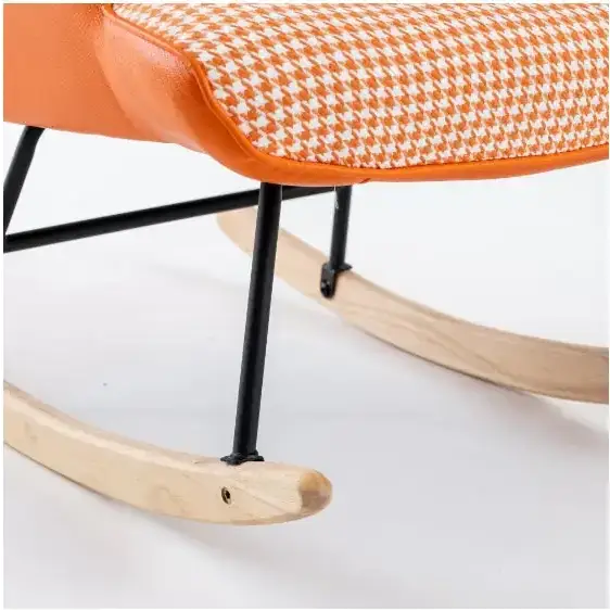 Orange and white houndstooth patterned rocking chair with black metal legs and light wood rockers.