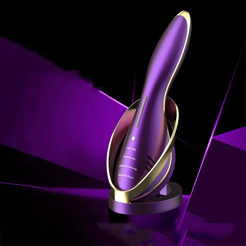 Purple and gold handheld facial device with sleek, ergonomic design.