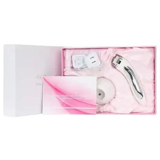 Silver-toned facial treatment device with a sleek, curved design and polished metallic finish.