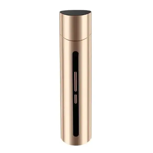 Gold-colored cylindrical device with a black top and vertical slot on the side.