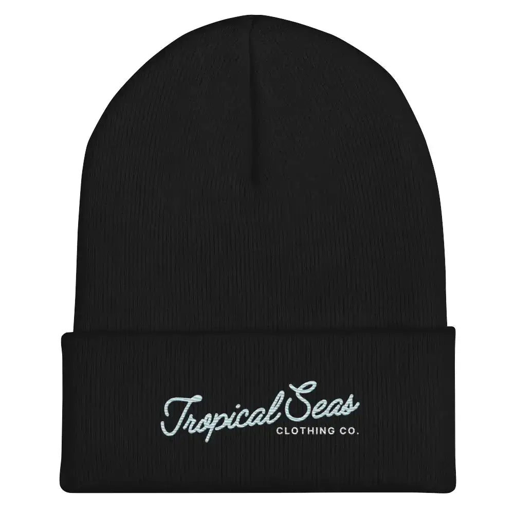 Black knit beanie with a folded cuff featuring white embroidered text reading ’tropical seas clothing co.’