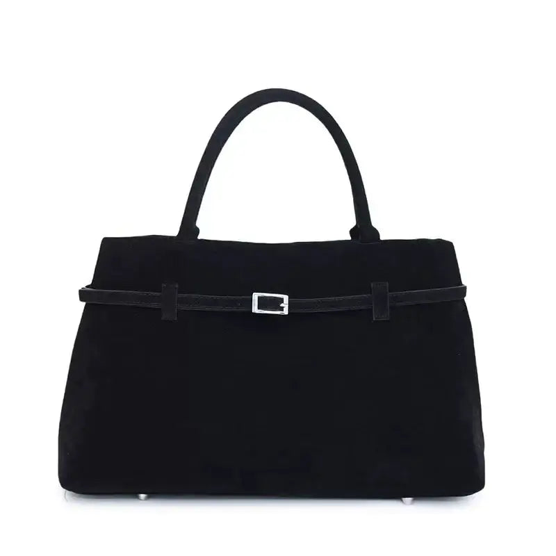 Black suede handbag with a silver buckle and matching handles.