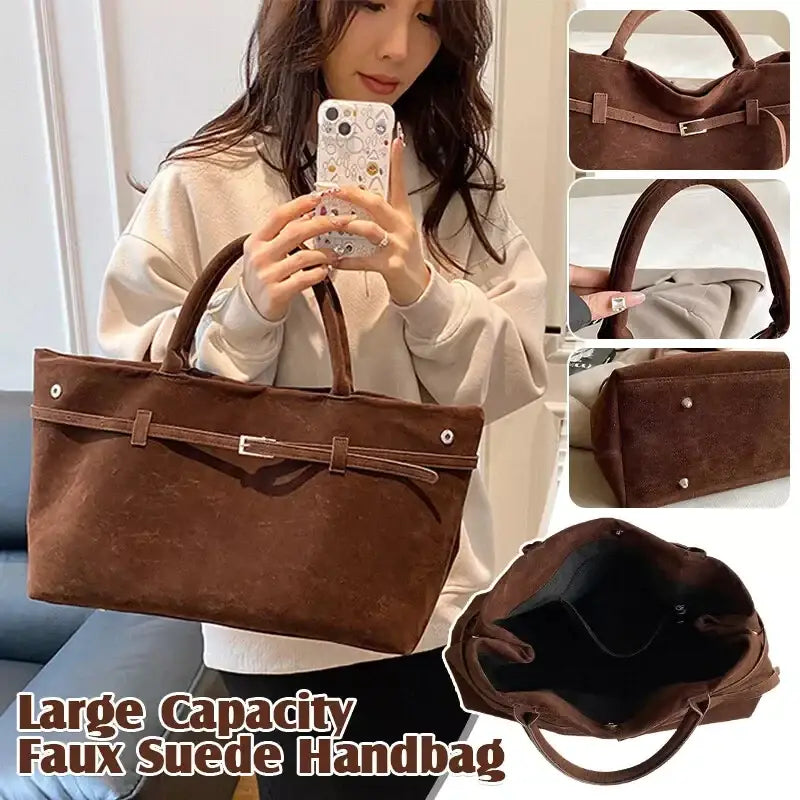 Brown faux suede handbag with a structured rectangular shape, featuring top handles and a front flap secured by a metallic buckle.
