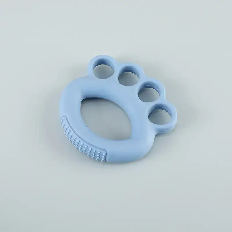 Light blue silicone baby teether shaped like a paw print with textured ridges on the underside.