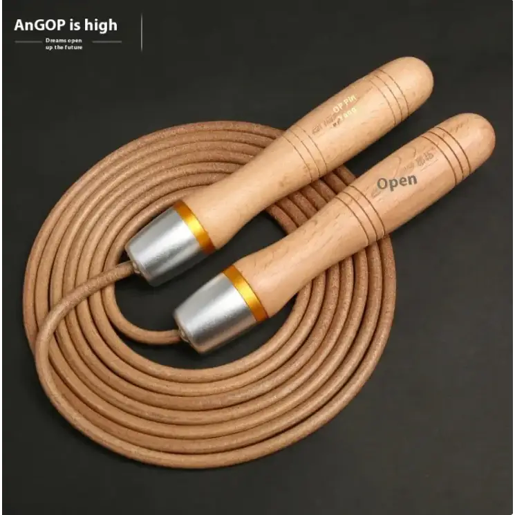 Wooden-handled jump rope with a tan leather cord and silver metal caps accented by gold bands.