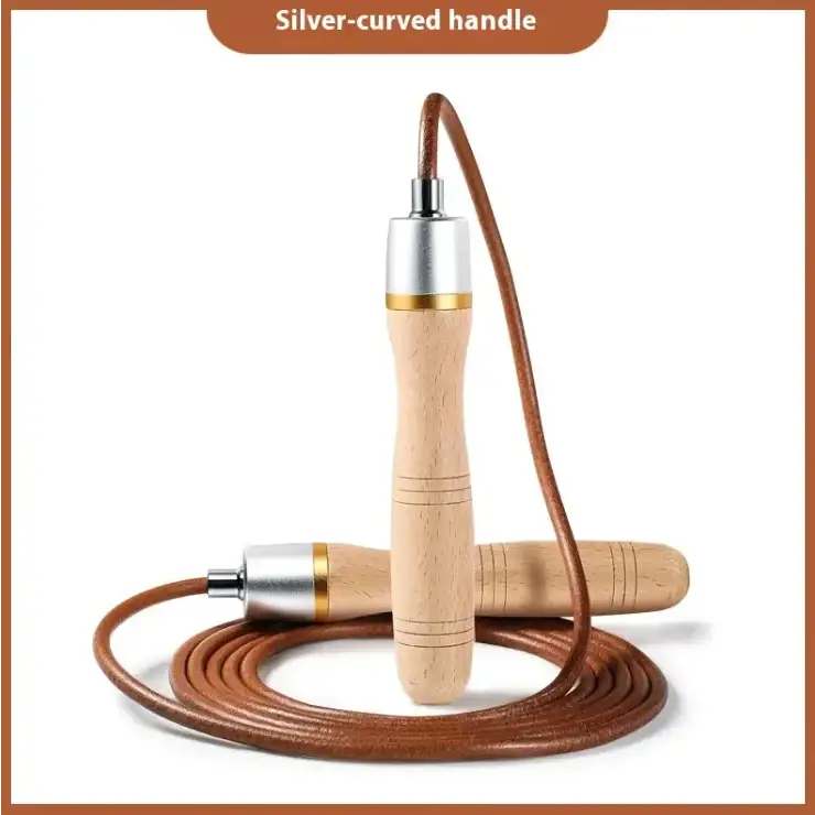 A jump rope with a silver-curved handle, light wood grips featuring subtle engraved lines, and brown leather cord.