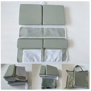 Gray fabric baby changing pad with mesh and solid panel sections.