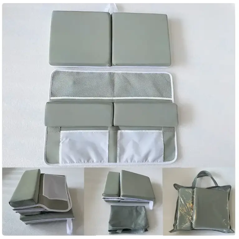 Gray fabric baby changing pad with mesh and solid panel sections.