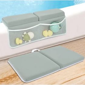 Gray inflatable bath safety pad with mesh storage pocket holding colorful toys.