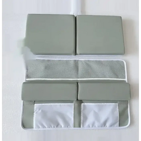 Gray padded baby safety mat with mesh and fabric storage pockets.
